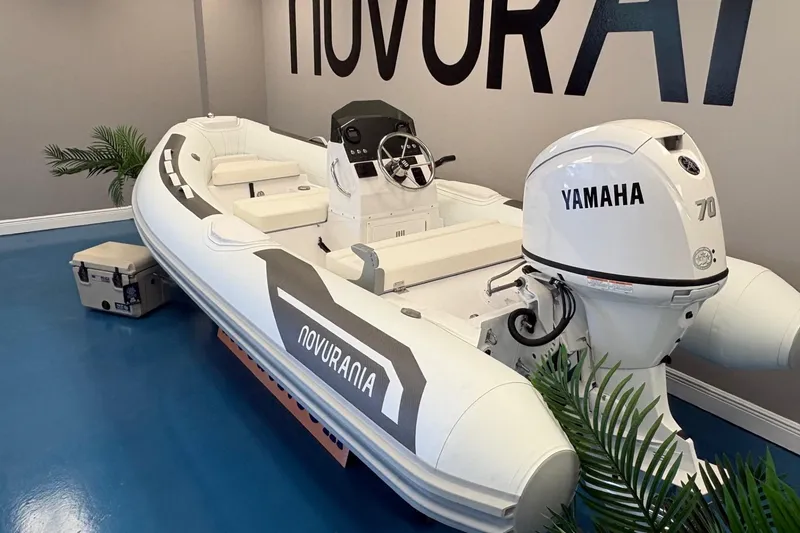 Slide: The Image of 2026 Novurania DL 430 boat with Yamaha 70 engine in showroom setting. - 3