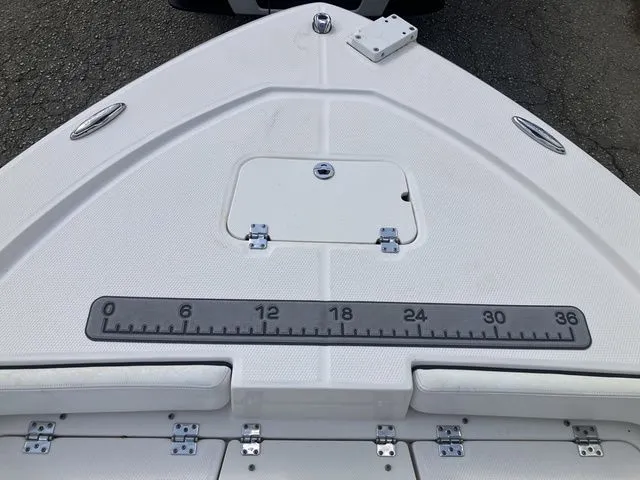 Slide: The Image of Bow view of a 2020 Robalo 206 Cayman boat with measuring strip. - 14