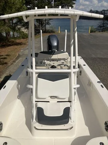 Slide: The Image of 2020 Robalo 206 Cayman boat with T-top by the water. - 16