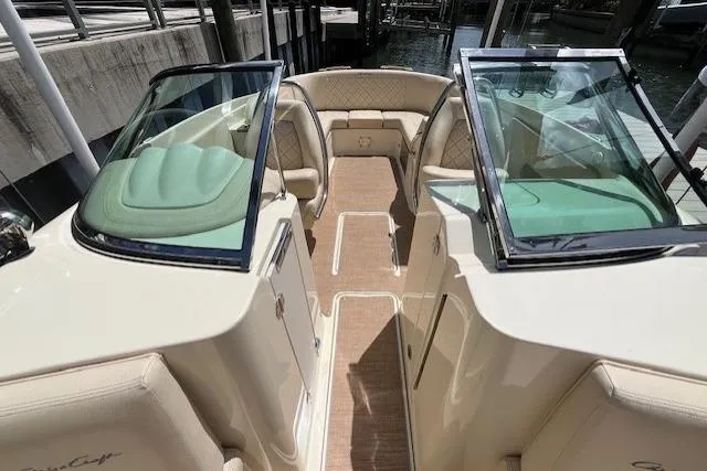 Slide: The Image of 2019 Chris-Craft Launch 27 boat interior with beige seating, speaker, and cup holder. - 19