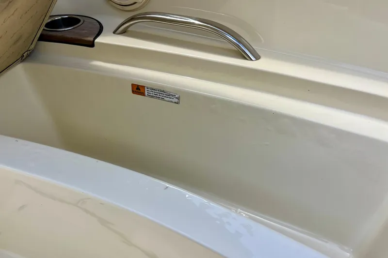 Slide: The Image of 2019 Chris-Craft Launch 27 interior detail with cup holder and safety warning label. - 22