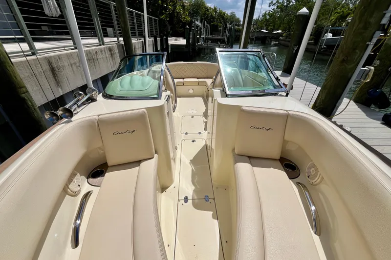 Slide: The Image of 2019 Chris-Craft Launch 27 boat interior with beige seating and open deck layout. - 25