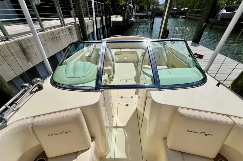 Slide: The Image of 2019 Chris-Craft Launch 27 boat docked, featuring elegant seating and sleek design. - 26