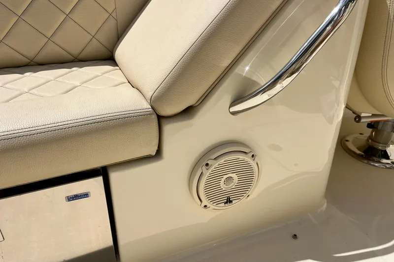 Slide: The Image of 2019 Chris-Craft Launch 27 interior with beige leather seating and speaker detail. - 33