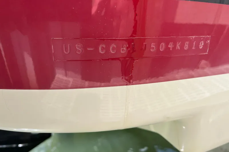 Slide: The Image of 2019 Chris-Craft Launch 27 boat hull identification number on red and white surface. - 35