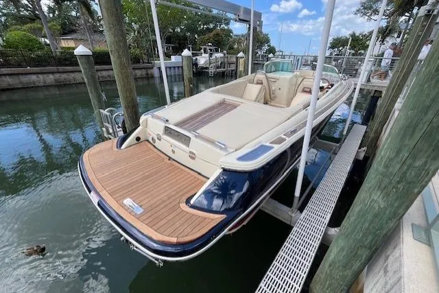 Slide: The Image of 2019 Chris-Craft Launch 27 boat docked, showcasing elegant design and luxurious seating. - 4