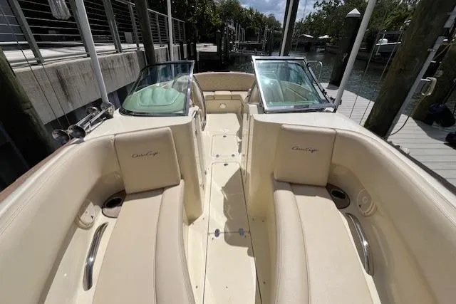 Slide: The Image of 2019 Chris-Craft Launch 27 boat interior with beige diamond-stitched seating and storage compartment. - 7