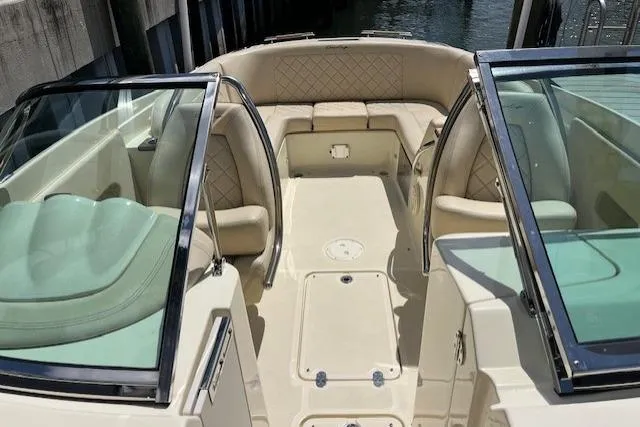 Slide: The Image of Luxurious 2019 Chris-Craft Launch 27 boat interior with elegant seating and wooden table. - 8