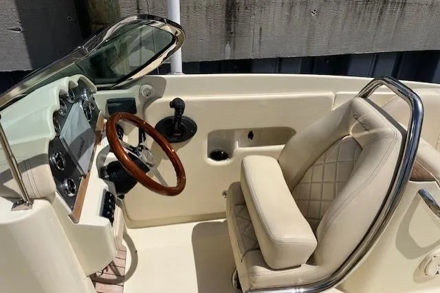 Slide: The Image of Luxurious beige seating on a 2019 Chris-Craft Launch 27 boat with diamond stitching. - 9