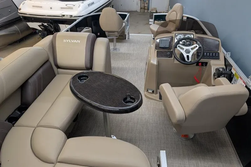 Slide: The Image of Interior of 2026 Sylvan Mirage Fish 818 Fish boat with beige seating and steering console. - 11