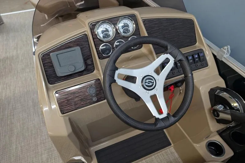 Slide: The Image of 2026 Sylvan Mirage Fish 818 Fish dashboard with steering wheel and control panel. - 7