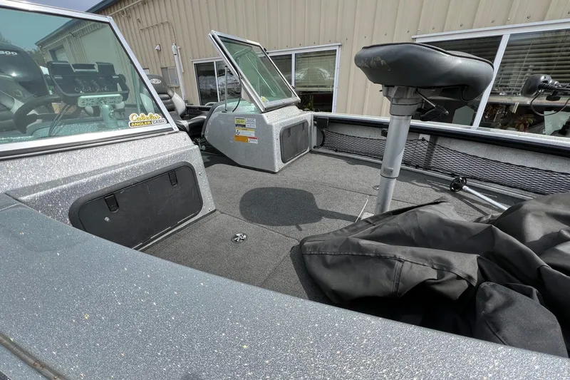 Slide: The Image of 2012 Lund 208 Pro-V GL boat interior with seating and storage compartments. - 12