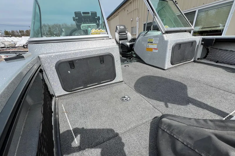 Slide: The Image of 2012 Lund 208 Pro-V GL boat interior with seating and storage compartments. - 13