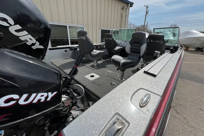 Slide: The Image of 2012 Lund 208 Pro-V GL boat interior with Mercury engine, featuring comfortable seating. - 16