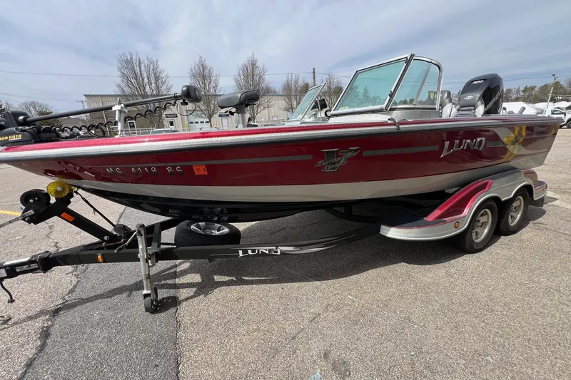 Slide: The Image of 2012 Lund 208 Pro-V GL boat on trailer, parked outdoors. - 3