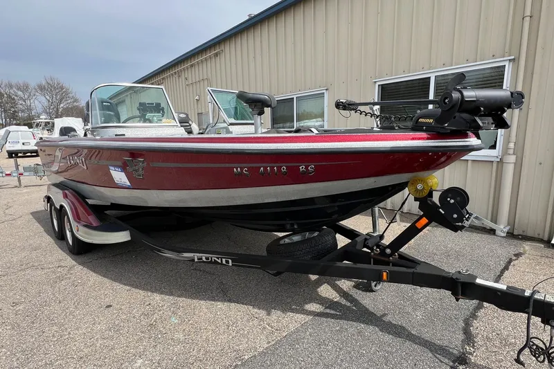 Slide: The Image of 2012 Lund 208 Pro-V GL boat on trailer, parked outside a building. - 7