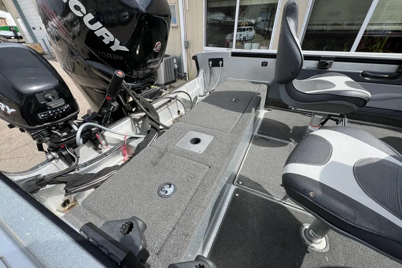 Slide: The Image of Interior of a 2012 Lund 208 Pro-V GL boat with Mercury engines and seating. - 8
