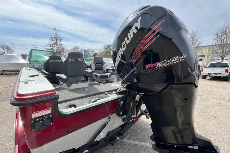 Slide: The Image of 2012 Lund 208 Pro-V GL boat with Mercury Pro FourStroke engine, parked outdoors. - 9