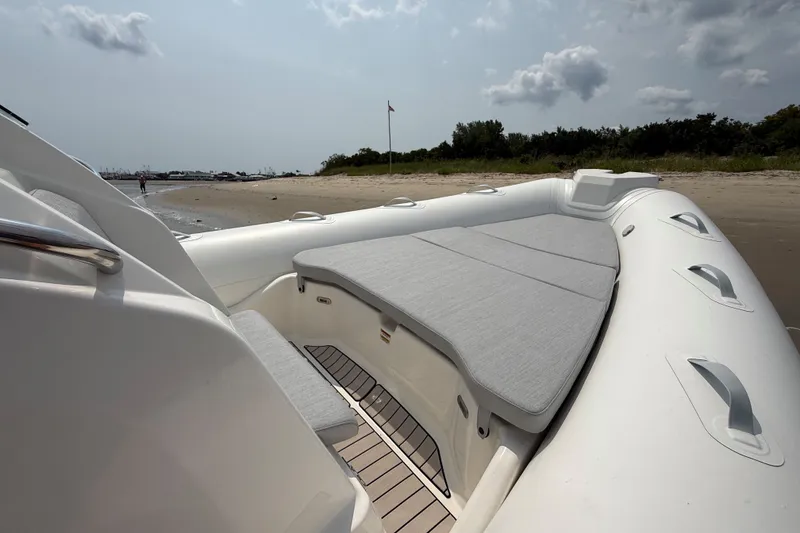 Slide: The Image of 2026 Zodiac Medline 7.5 boat with cushioned seating on a sandy beach. - 17