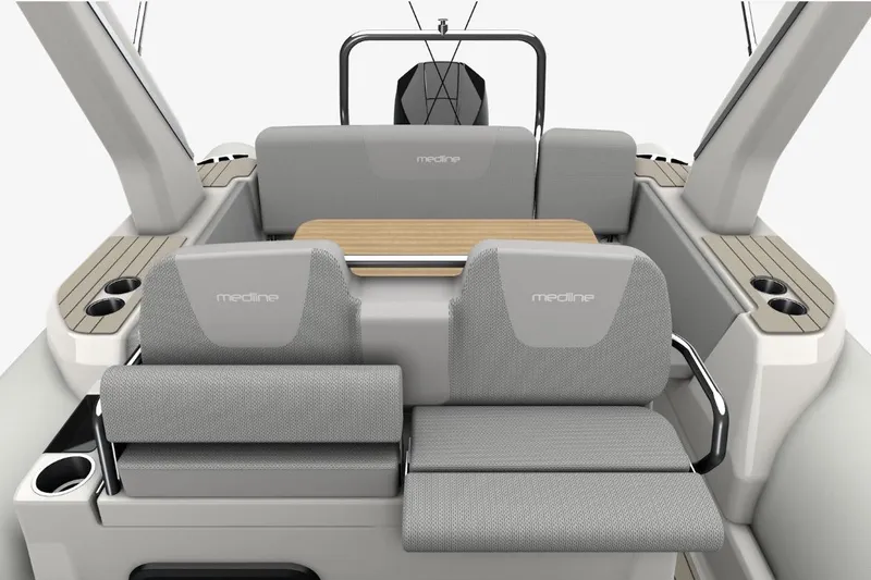 Slide: The Image of 2026 Zodiac Medline 7.5 boat interior with gray seating and wooden table. - 13