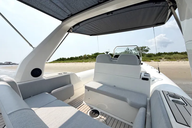 Slide: The Image of 2026 Zodiac Medline 7.5 boat interior with canopy, docked on a sandy beach. - 7