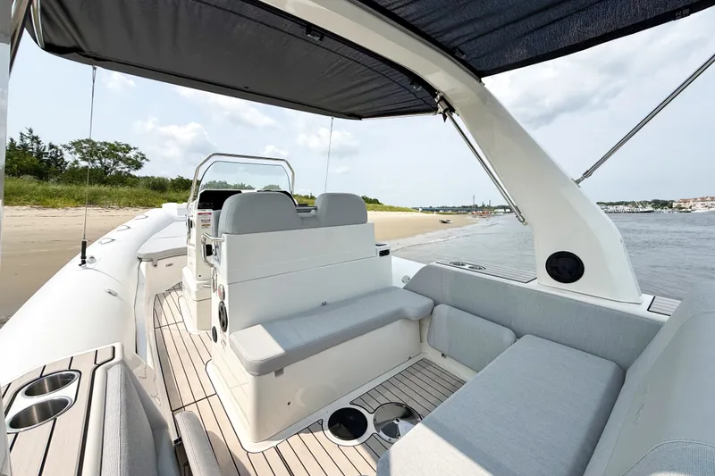 Slide: The Image of 2026 Zodiac Medline 7.5 boat interior with seating, near a sandy beach. - 5
