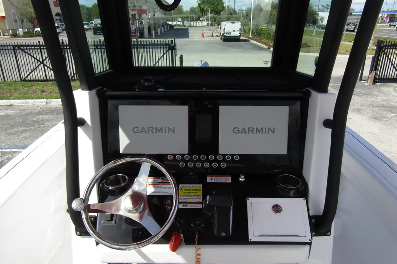 Slide: The Image of 2024 Wellcraft 223 Fisherman dashboard with dual Garmin displays and steering wheel. - 10