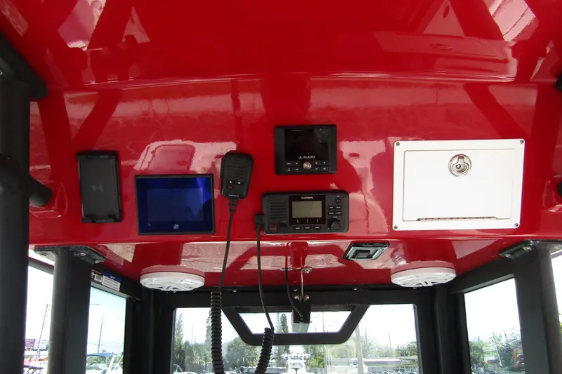 Slide: The Image of 2024 Wellcraft 223 Fisherman boat console with red finish and electronic controls. - 13