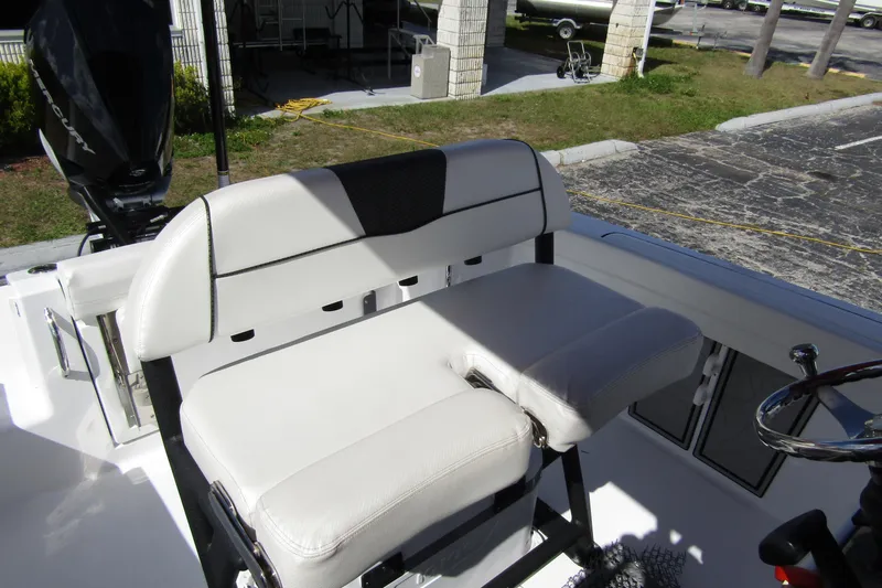 Slide: The Image of 2024 Wellcraft 223 Fisherman boat interior with white seating and steering wheel. - 15
