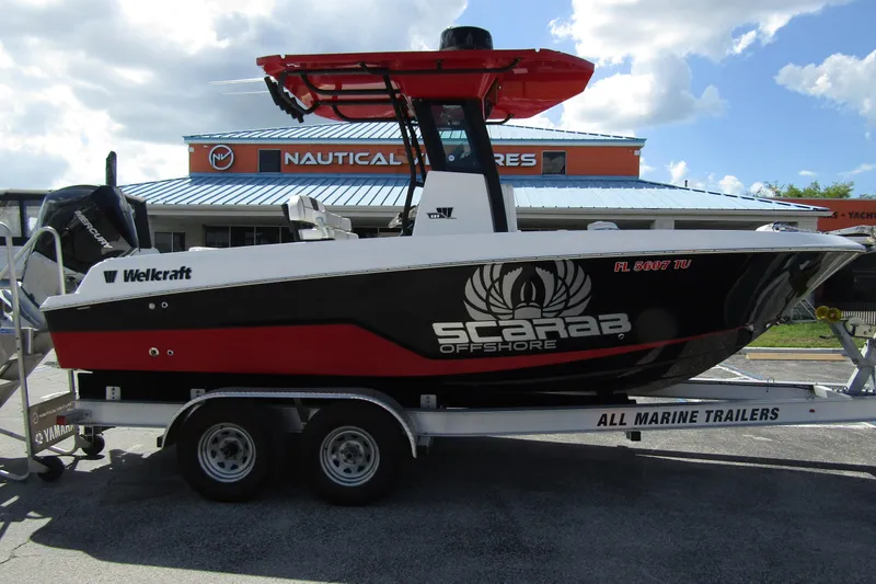 Slide: The Image of 2024 Wellcraft 223 Fisherman boat on trailer, displayed at a nautical store. - 4