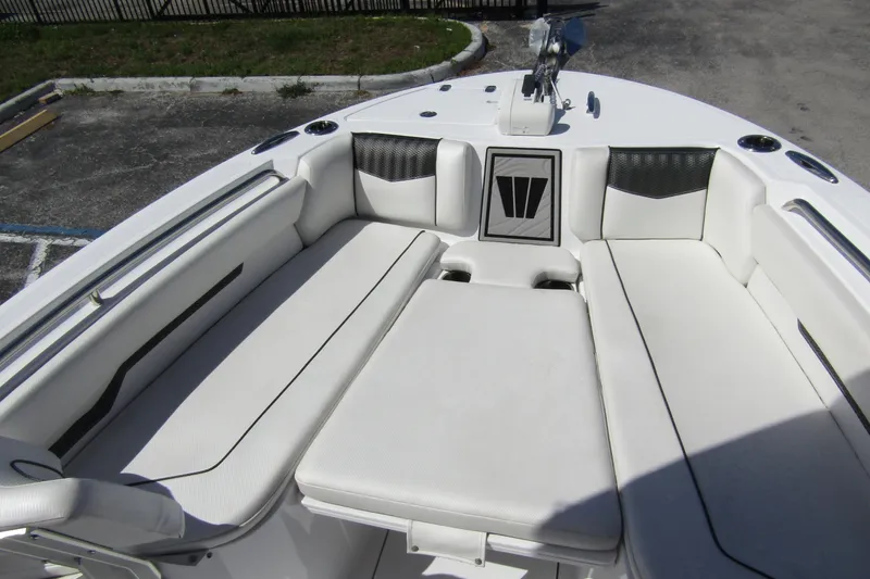 Slide: The Image of 2024 Wellcraft 223 Fisherman boat interior with white cushioned seating and sleek design. - 7