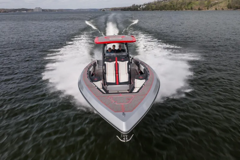 Slide: The Image of 2021 Fountain 38 SC speedboat cruising on a lake, showcasing sleek design and powerful performance. - 11