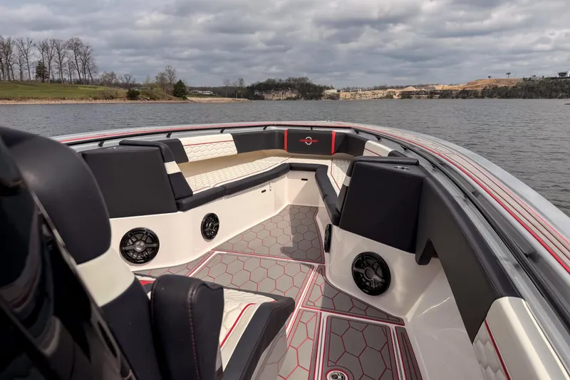 Slide: The Image of 2021 Fountain 38 SC boat interior with stylish seating and speakers on a lake. - 13