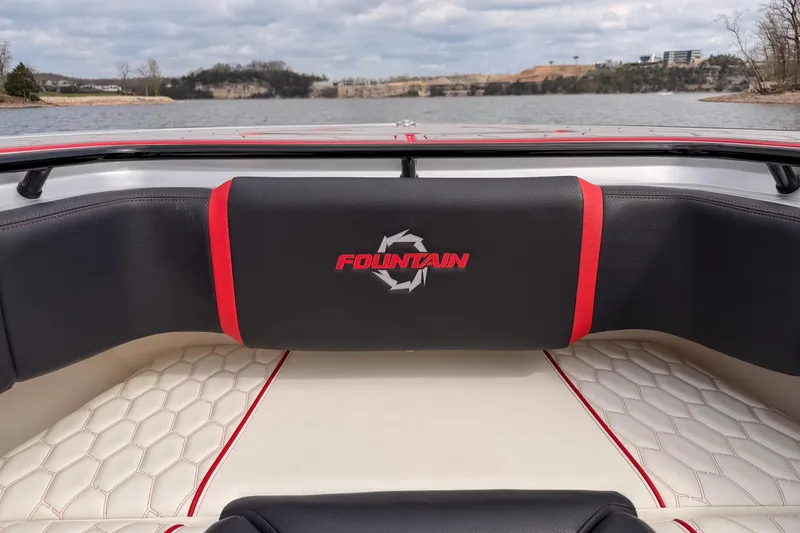 Slide: The Image of 2021 Fountain 38 SC boat interior with logo, featuring luxurious seating and scenic lake view. - 16