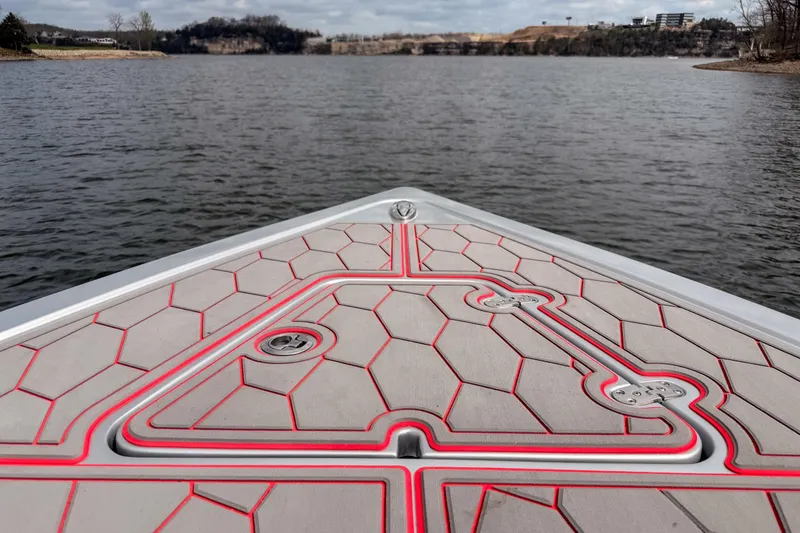 Slide: The Image of Bow of 2021 Fountain 38 SC boat with geometric deck design on a lake. - 17