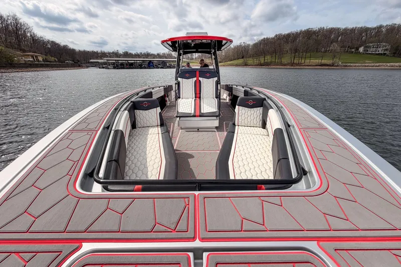 Slide: The Image of 2021 Fountain 38 SC boat with stylish seating and modern design on a serene lake. - 18