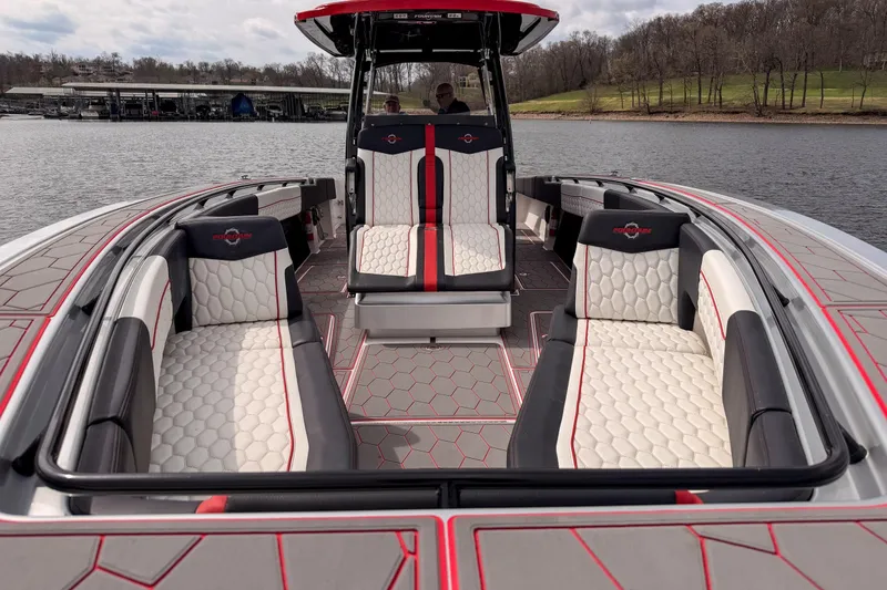 Slide: The Image of 2021 Fountain 38 SC boat interior with stylish seating and modern design on a lake. - 19