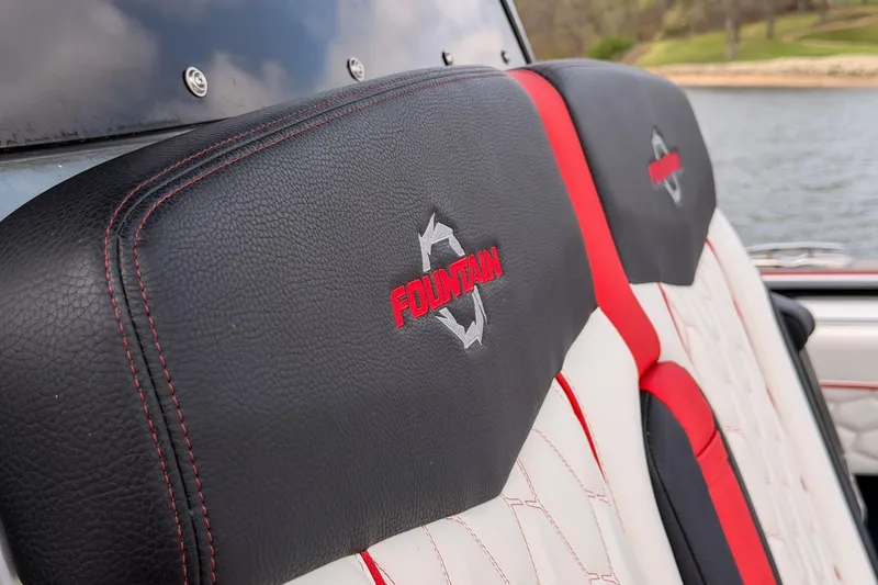 Slide: The Image of 2021 Fountain 38 SC boat seat with logo, featuring black and red stitching. - 22