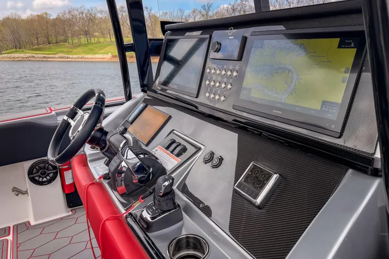 Slide: The Image of 2021 Fountain 38 SC boat dashboard with advanced navigation displays and controls. - 28