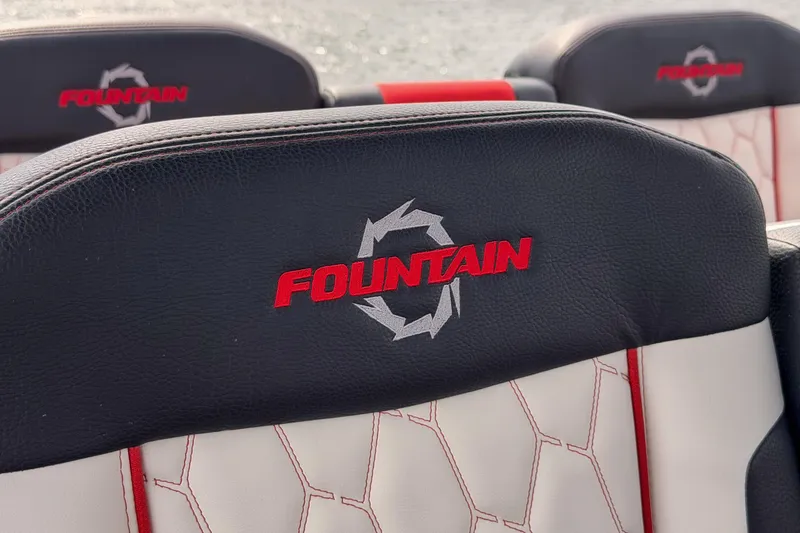 Slide: The Image of 2021 Fountain 38 SC boat seats with embroidered logo, featuring black and white upholstery. - 31