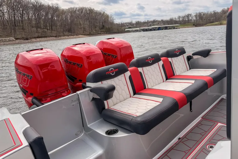 Slide: The Image of 2021 Fountain 38 SC boat with red racing engines and stylish seating on a lake. - 32