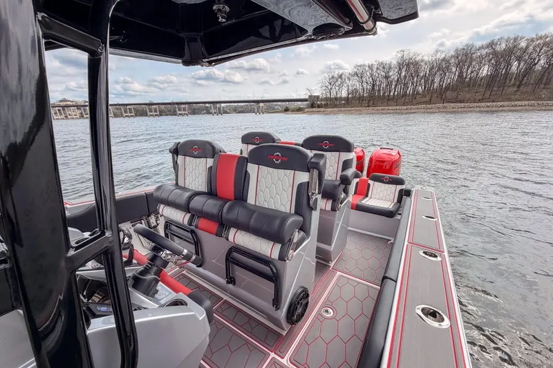 Slide: The Image of 2021 Fountain 38 SC boat interior with stylish seating on a calm lake. - 39