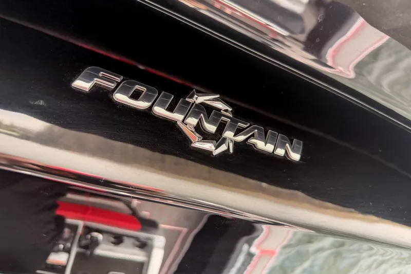 Slide: The Image of 2021 Fountain 38 SC boat logo on sleek black surface. - 43
