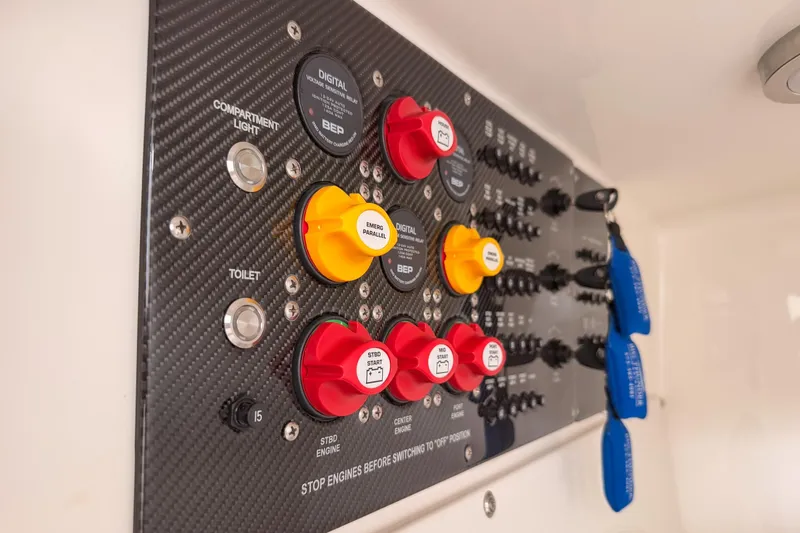 Slide: The Image of Control panel of a 2021 Fountain 38 SC boat with switches and keys. - 49