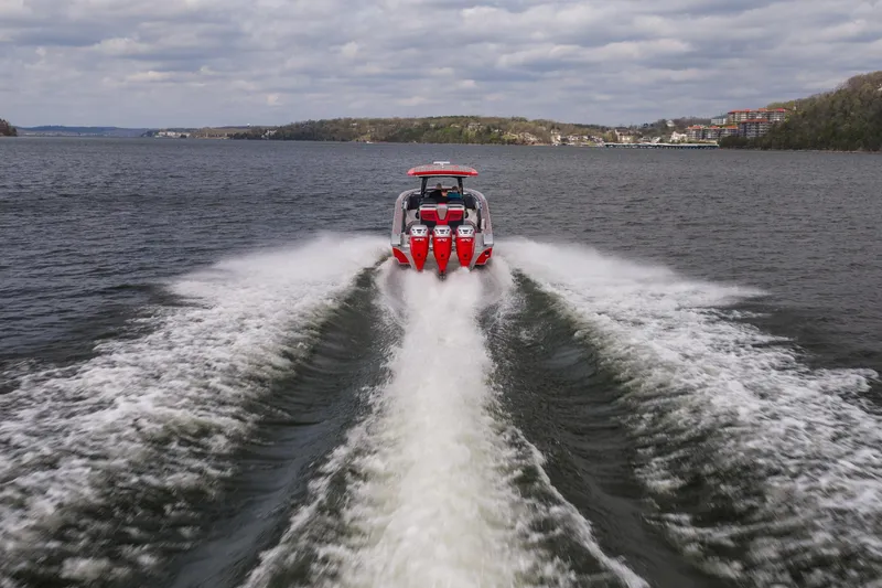 Slide: The Image of 2021 Fountain 38 SC boat speeding on a lake, leaving a wake trail. - 5