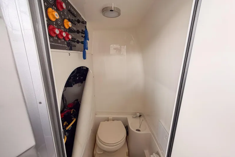 Slide: The Image of 2021 Fountain 38 SC boat interior with control panel and compact bathroom. - 51