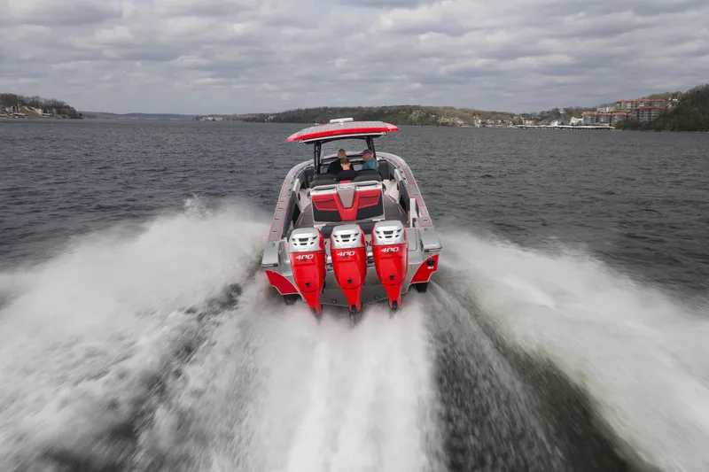 Slide: The Image of 2021 Fountain 38 SC boat speeding on a lake with triple 400 engines. - 6