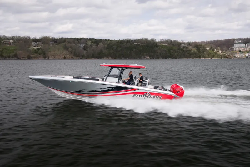 Slide: The Image of 2021 Fountain 38 SC speedboat cruising on a lake with passengers onboard. - 8