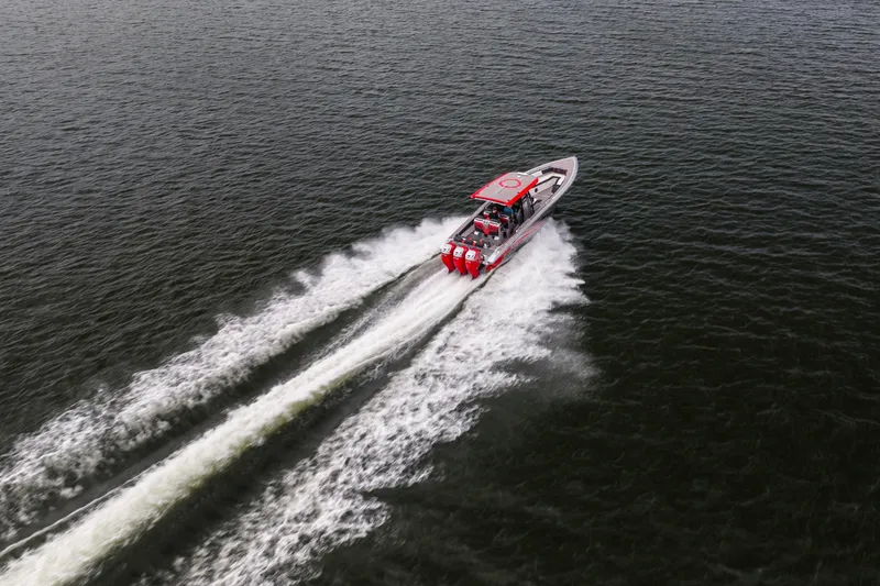 Slide: The Image of Aerial view of 2021 Fountain 38 SC speedboat cruising on open water. - 9
