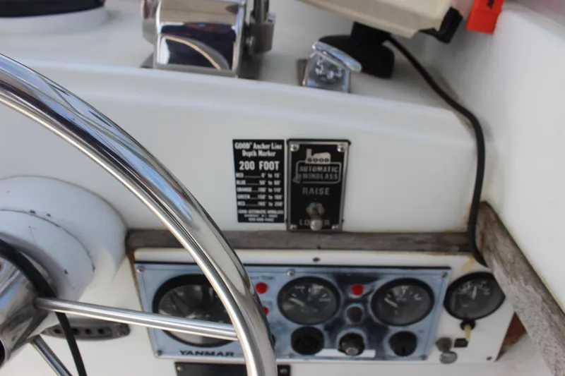 Slide: The Image of 1979 Tripp Angler 22 Flush Deck Cuddy helm with steering wheel and control panel. - 11